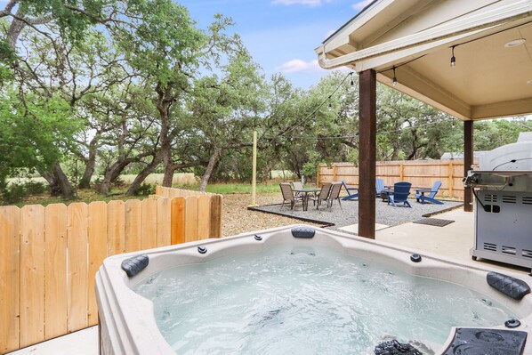 The backyard has a hot tub and plenty of seating perfect for entertaining