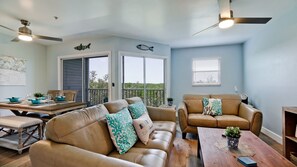 Open concept living room with lots of natural lighting.