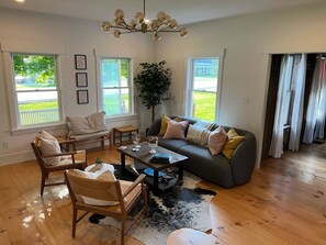 The sitting room bursts with natural light and provides extra space to enjoy a local brew and relax. From here, you're in the center of the action between the kitchen and Great Room.