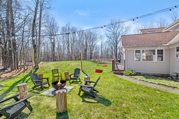 **Wood Burning Fire Pit** Grab a spot in the backyard by the fire pit, under the string lights and take in the peacefulness of the Poconos!