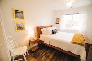 Sunny and bright bedroom with a queen-size bed.