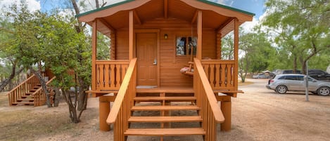 Cozy log cabin with porch swing.