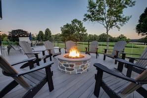 Gather round the outdoor fireplace on the deck with friends and family for an incredible evening.