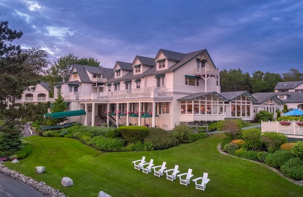 Unwind where timeless charm meets coastal calm, with sweeping porches and garden-lined views.