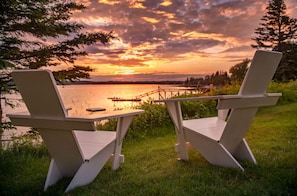 Escape for the ultimate getaway as golden skies melt into calm harbor waters.