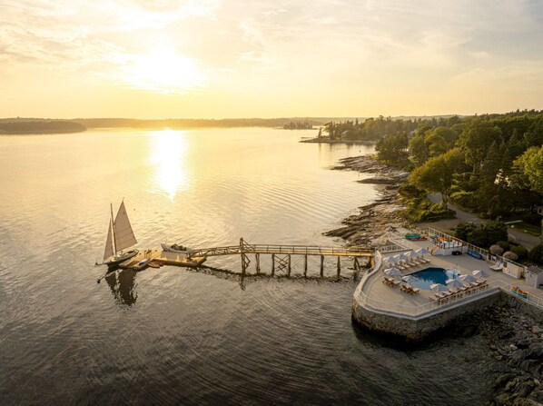 Watch the sun sink over sparkling waters where peaceful docks and gentle waves set the pace.