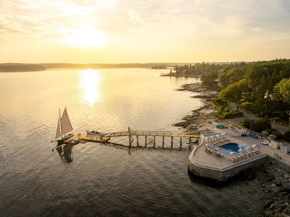 Watch the sun sink over sparkling waters where peaceful docks and gentle waves set the pace.