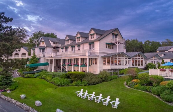 Unwind where timeless charm meets coastal calm, with sweeping porches and garden-lined views.