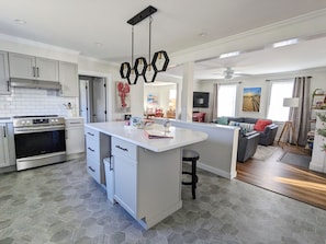 Well-appointed kitchen with island seating, open to living room