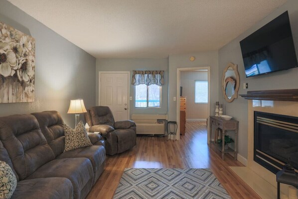 Living room view towards master bedroom and private deck with river view