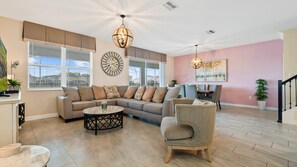 Stylish open living space with cozy seating, dining area, and decor!