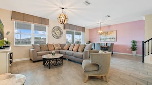 Stylish open living space with cozy seating, dining area, and decor!