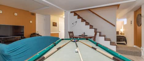 An original mini pool table compliments the lower level of the home.  Other games and a video game console included.