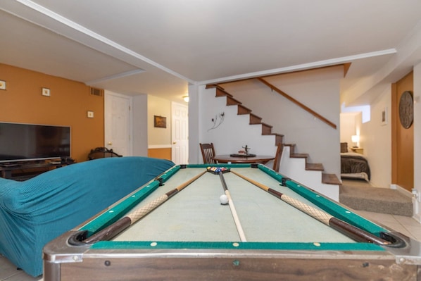 An original mini pool table compliments the lower level of the home.  Other games and a video game console included.