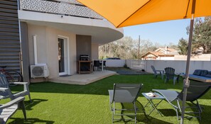 Large garden with sun loungers, lower lounge and dining area