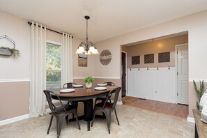 Dining area [seats 4 at table, 3 at bar]