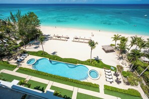 Aerial view of the resort's pool, heated spas, and dreamy beachfront.  