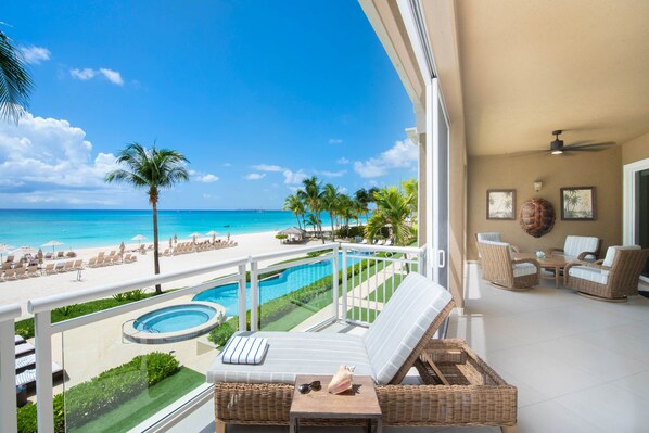 Screened balcony with elevated views of the ocean.