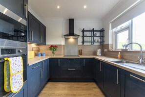 Kitchen fully equipped with oven , hob, microwave, dishwasher, washing machine and coffee machine