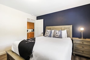 This inviting bedroom just off of the kitchen boasts a queen-size bed, nightstand and lamp, bright linens and fun, mountain modern decor, making it a cozy place to curl up for the evening.