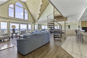 The great room brings everyone together with a superb open layout complemented by soaring cathedral ceilings and stunning ocean views.