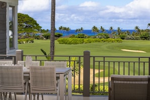 The lanai overlooks the Palm Villa greenery and the horizon