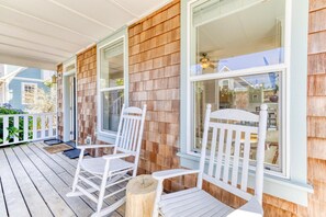Covered front porch with rocking chairs and the cedar shake exterior