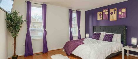 The “purple” room like the other rooms, contains beautiful hardwood flooring, a bedside nightstand on each side and blackout curtains to ensure a good nights sleep. 