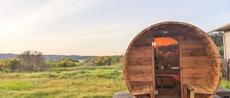 Cedar barrel sauna with panoramic bubble window allows you to take in the views.