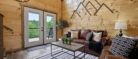 Main living room with high vaulted ceilings.  Has walk out to upper patio deck.