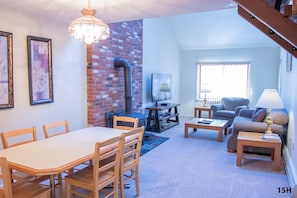 Living area has a 60-inch Flat Screen TV.  Dining area is open to the living area.