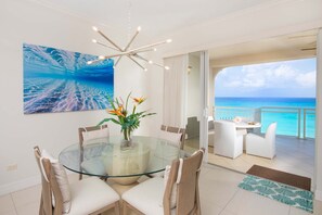 Dine indoors or out on the balcony with sweeping seaside views.