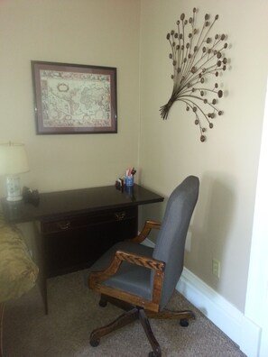 Comfortable desk with rolling executive chair.