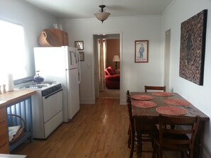 Bright fully appointed kitchen with dining table.