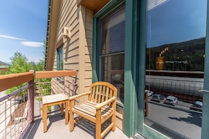 Private balcony with seating and ski slope views.