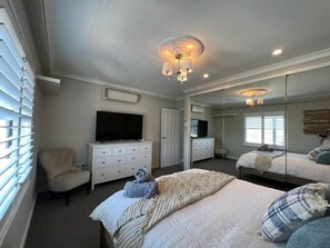 Large main bedroom with private TV and air conditioner