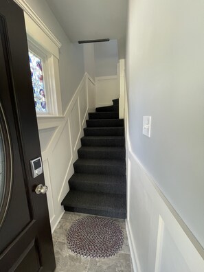 lovely, well-lit, re=built stairwell provides a tasteful setting for arrival.