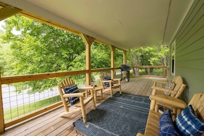 Front covered deck with sitting area and grill