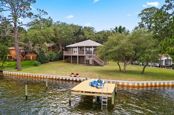 View from the back of the house; home is 1 story, despite appearances; 5 ft, black aluminum fence (not pictured) now runs between our home and the neighbor's on the left side of this photo; other side of house is fenced in toward the back of the back yard