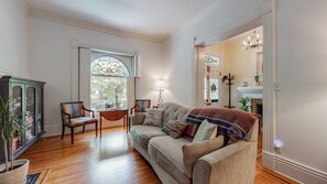 Living Room with natural light and original shutters, stained glass and flooring