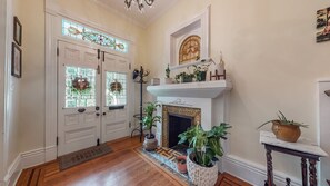 Foyer with original in-lay hardwood and stained glass windows