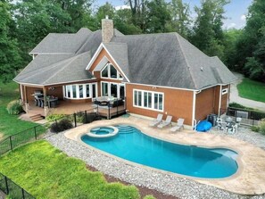 Aerial View of the house and pool area. Round sitting area in the pool is perfect for relaxing on hot days!