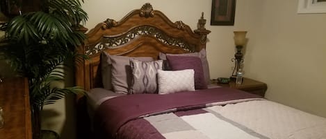 Queen size bed with high-quality sheets and comforter