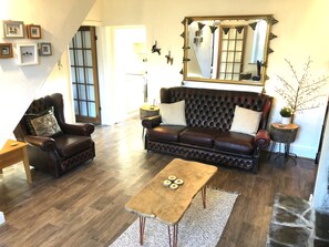 Lounge with Chesterfield sofa and 2 armchairs.