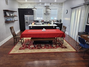 Dining area and kitchen. Desk with monitor, printer and Alexa show.