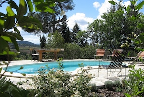 The inviting pool has a large deck with seating, lounging and dining areas.