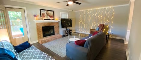 Living Room with Sofa, Recliner, Futon, Fireplace, Smart TV, and Wall of Lights