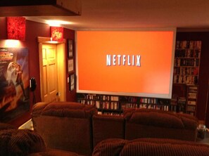 Audience view of 8 foot wide screen streaming Netflix movies.