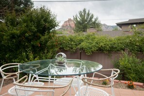 The outdoor dining area seats four