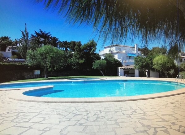 Large swimming pool and separate children's pool with lawned areas and terraces